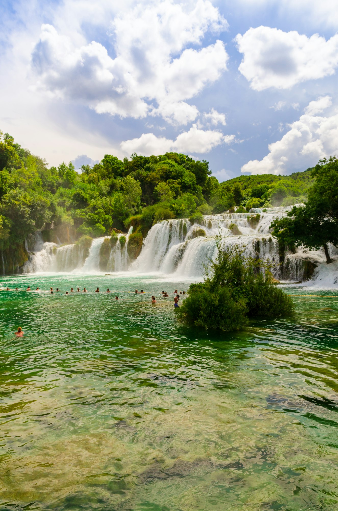 Waterfalls of Croatia.Tourists swimming near waterfalls in crystal clear water. Tourist spot in